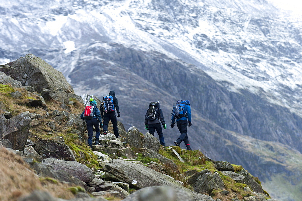 Hikers set off from Pen Y Pass in winter to climb Mount Snowdon in Snowdonia National Park, Gwynedd, Wales, United Kingdom, Europe