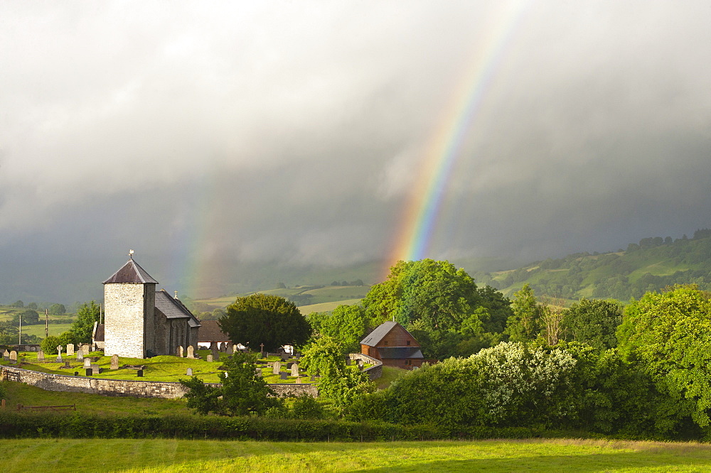 A rainbow over St. David's Church in the tiny Welsh hamlet of Llanddewir Cwm, Powys, Wales, United Kingdom, Europe