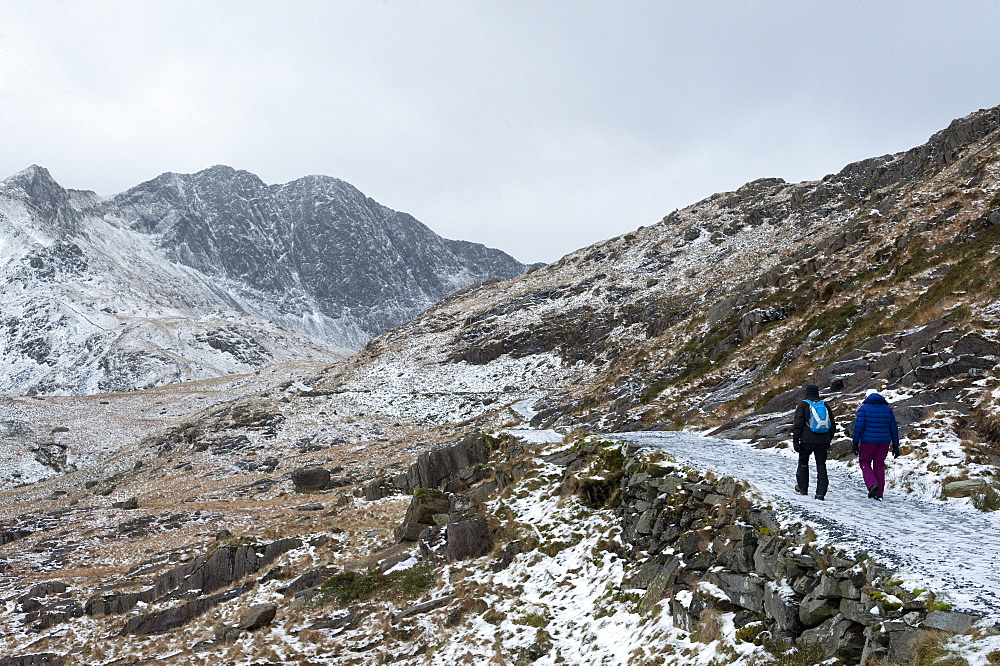 Hikers on the Miner's Track at base of Mount Snowdon in a wintry landscape in the Snowdonia National Park, Gwynedd, Wales, United Kingdom, Europe