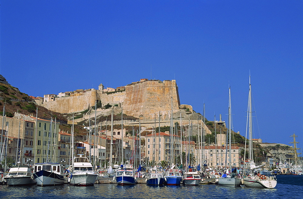 Yachts moored in the harbour, with waterfront and the citadel behind, Bonifacio, island of Corsica, France, Mediterranean, Europe