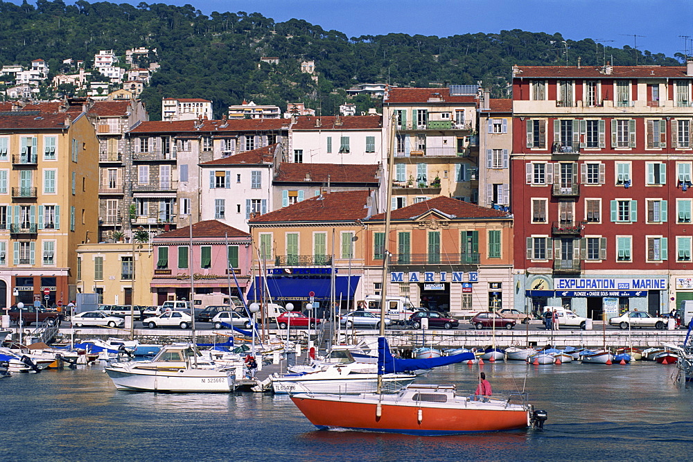 Boats moored in the harbour and houses on waterfront, Nice, Alpes Maritimes, French Riviera, Provence, France, Europe