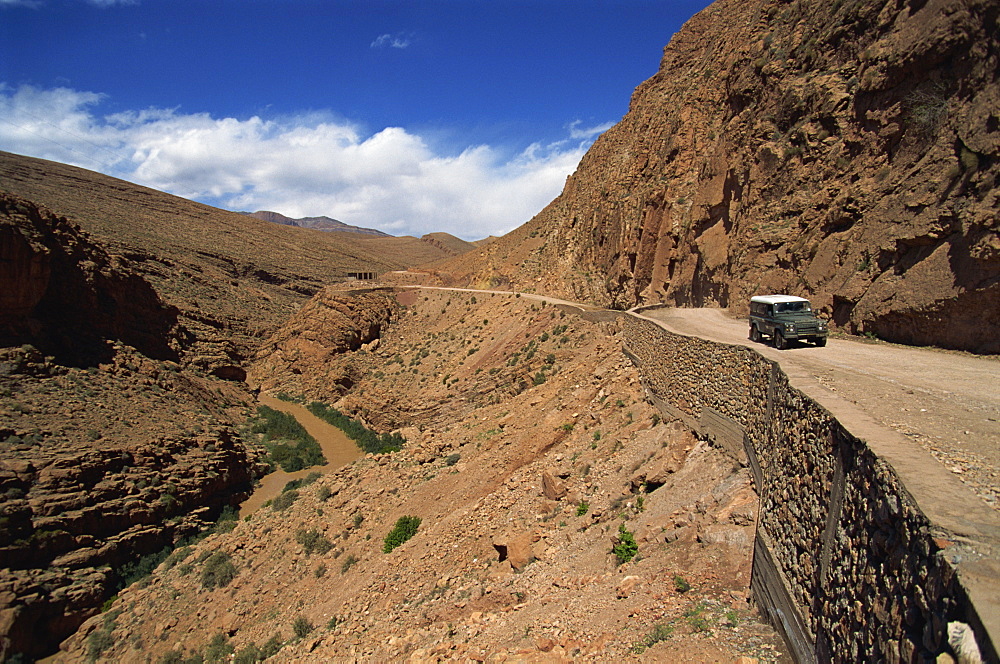 Four-wheel drive vehicle on a road through the Atlas Mountains, in the arid Dades Valley, Morocco, North Africa, Africa