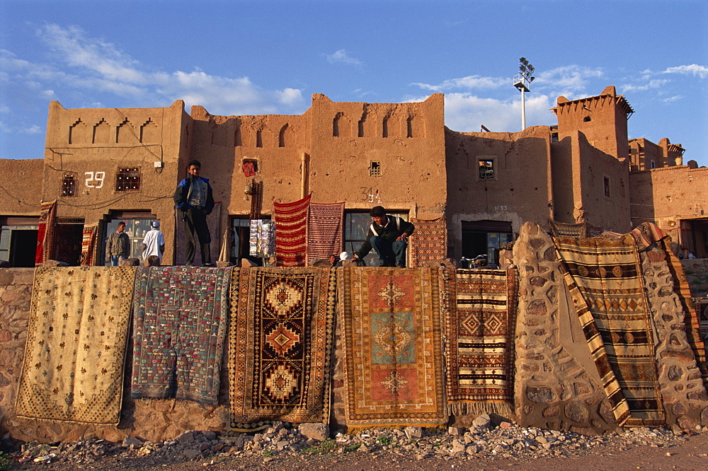 Carpets and rugs displayed on walls outdoors for sale at the Taourirt Kasbah, Ouarzazate, Morocco, North Africa, Africa