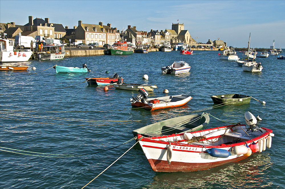 Harbour and fishing boats with houses and church in the background, Barfleur, Manche, Normandy, France, Europe