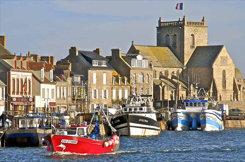 Harbour and fishing boats with houses and church in the background, Barfleur, Manche, Normandy, France, Europe