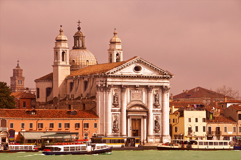 Facade and domes of the 18th century Gesuati church, Zattere, Dorsoduro quarter, and Giudecca Canal with vaporetto in the evening, Venice, UNESCO World Heritage Site, Veneto, Italy, Europe