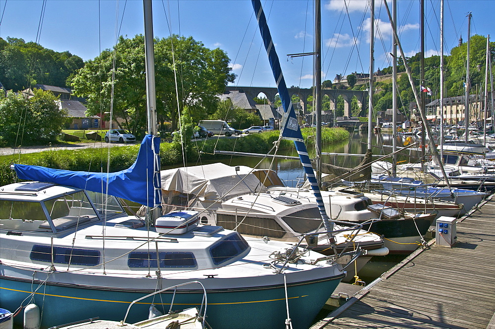 Sailboats moored on River Rance, with viaduct in the background, Dinan harbour, Brittany, France, Europe