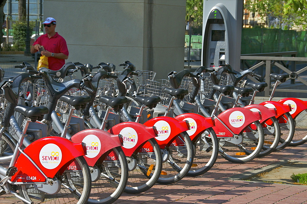 Parked Red Bikes for hire, Seville, Andalusia, Spain, Europe