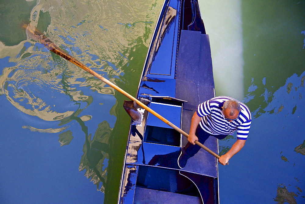 Gondolier on his gondola, Venice, UNESCO World Heritage Site, Veneto, Italy, Europe