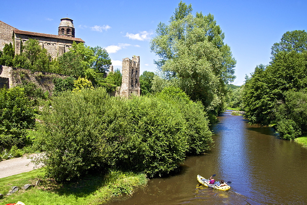 Ruins and Benedictine abbey tower, along the Senouire river, and canoeing, at Lavaudieu, a medieval village, Auvergne, Haute Loire, France, Europe