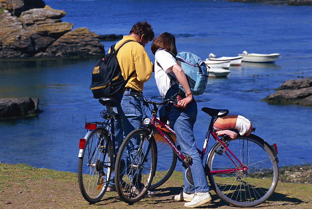 Tourists on bikes, Saint Nicolas Port, Ile de Groix, Brittany, France, Europe