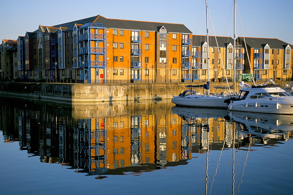 Apartments and reflection in water, Swansea Marina, Swansea, Wales, United Kingdom, Europe