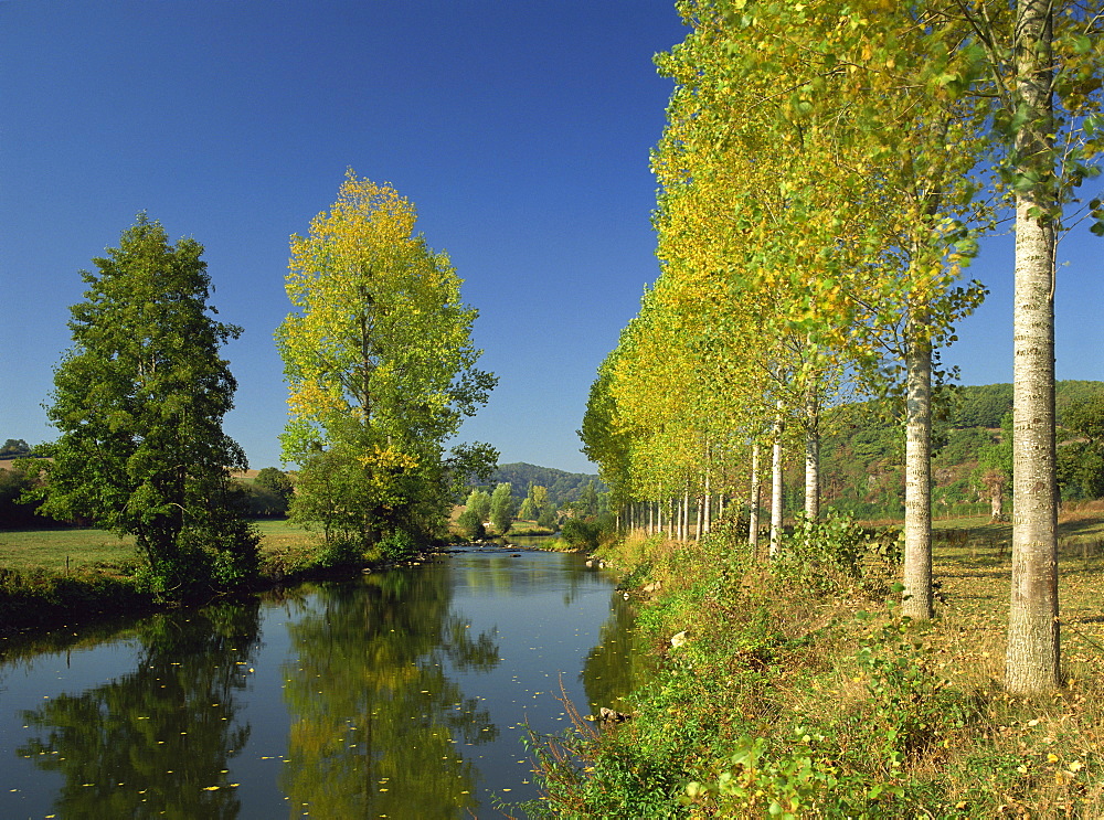 Tranquil scene of trees reflected in water, along the banks of the River Sarthe near St. Ceneri Le Gerie, Orne, Basse Normandie (Normandy), France, Europe