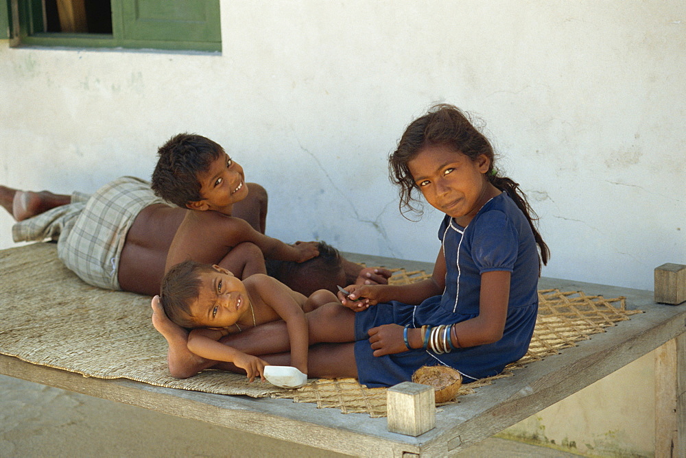 Portrait of a group of three small children, smiling and looking at the camera, Maldive Islands, Indian Ocean, Asia