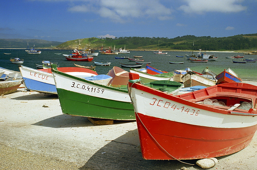 Fishing boats on the beach and in the harbour of the village of Muxia in Galicia, Spain, Europe