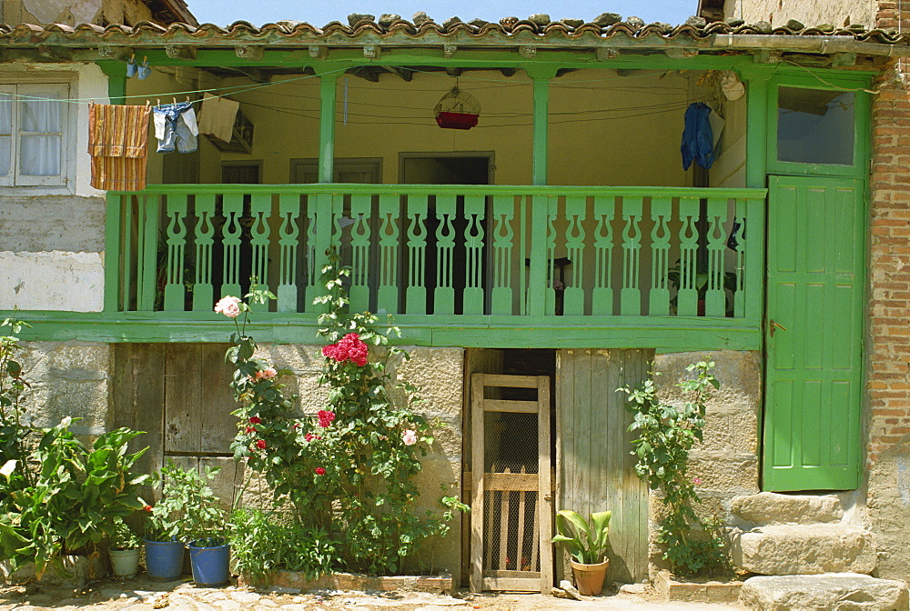 Detail of the exterior of a house with a green door and woodwork, Arenas de San Pedro, Spain, Europe