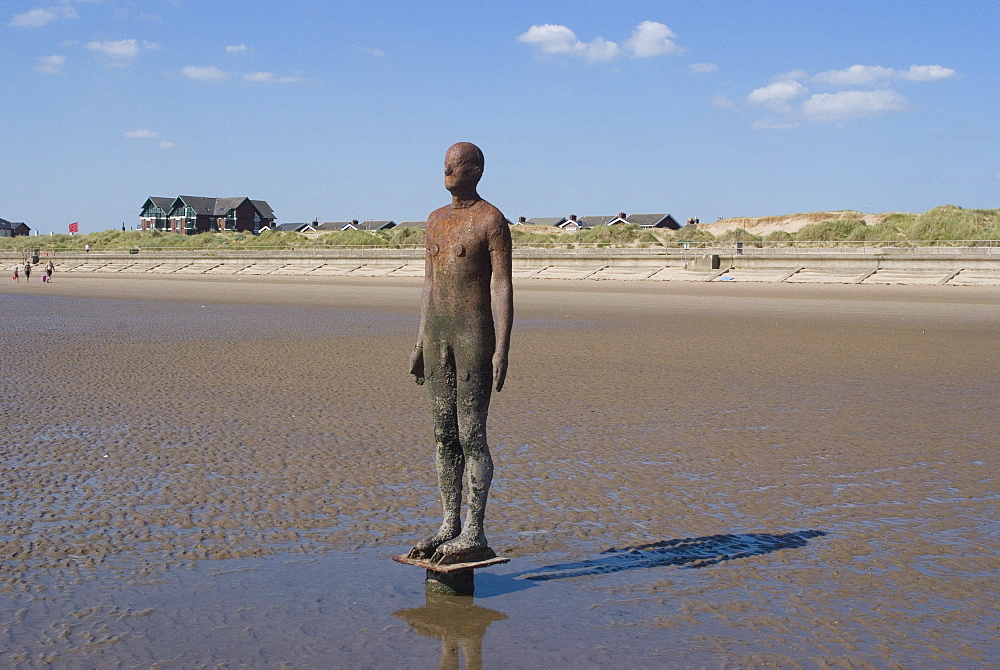 One of the 100 men of Another Place, also known as The Iron Men, statues by Antony Gormley, Crosby Beach near Liverpool, Merseyside, England, United Kingdom, Europe