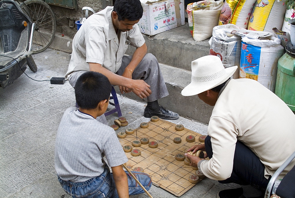 Playing a board game, Barkhor, Lhasa, Tibet, China, Asia