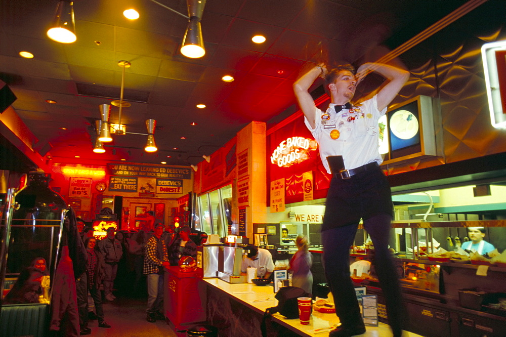 Young man dancing on bar counter, Chicago, Illinois, United States of America, North America