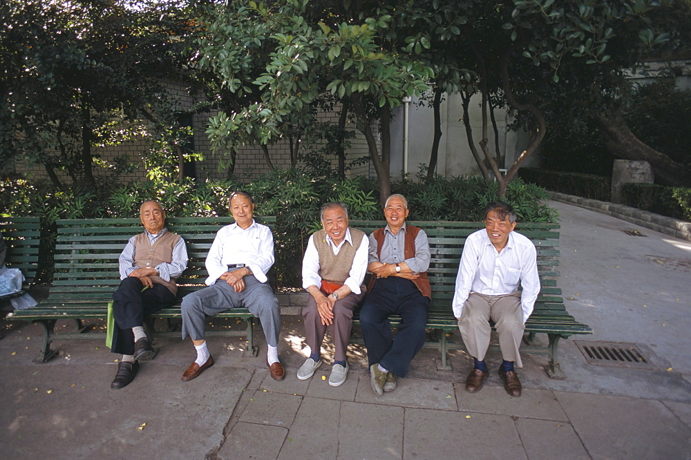 Group of men on bench, Shanghai, China, Asia