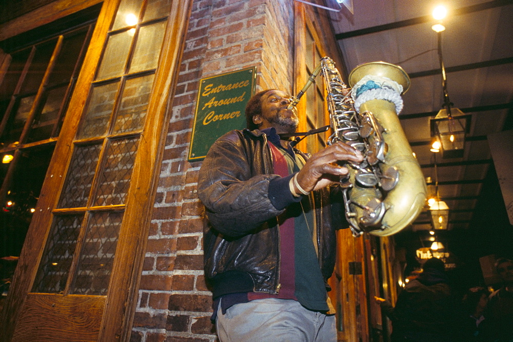 Jazz saxophonist playing at night in Bourbon Street, New Orleans, Louisiana, United States of America, North America