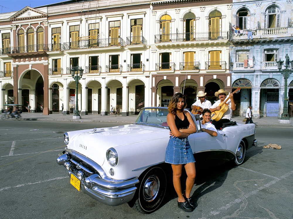 Young couple and musicians in old American car, Havana, Cuba, West Indies, Central America