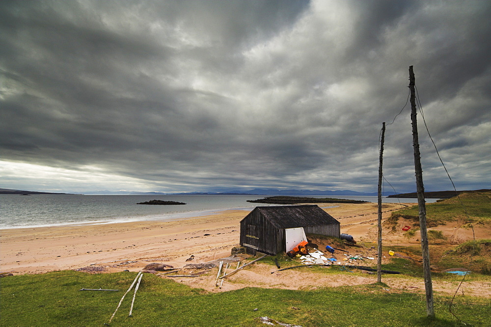 Stormy sky with fisherman's hut and net drying poles, Redpoint beach, Wester Ross, Scotland, United Kingdom, Europe