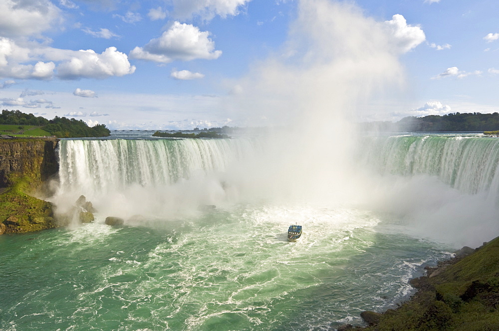 Maid of the Mist tour excursion boat under the Horseshoe Falls waterfall at Niagara Falls, Ontario, Canada, North America