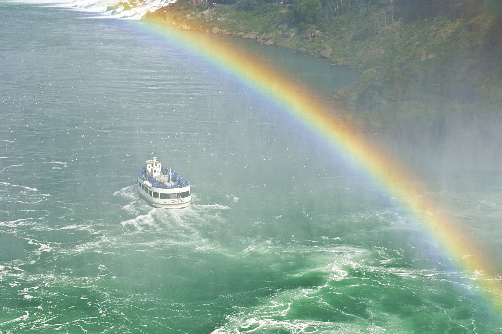 Maid of the Mist tour excursion boat under the Horseshoe Falls waterfall with rainbow at Niagara Falls, Ontario, Canada, North America