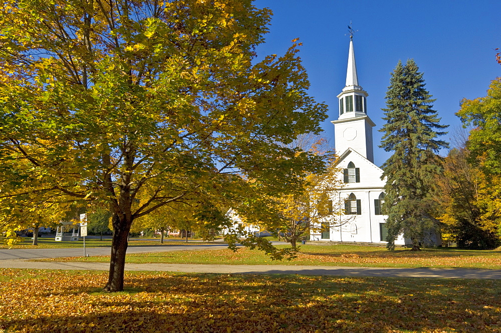 Autumn colours around traditional white timber clapperboard church, Townshend, Vermont, New England, United States of America, North America