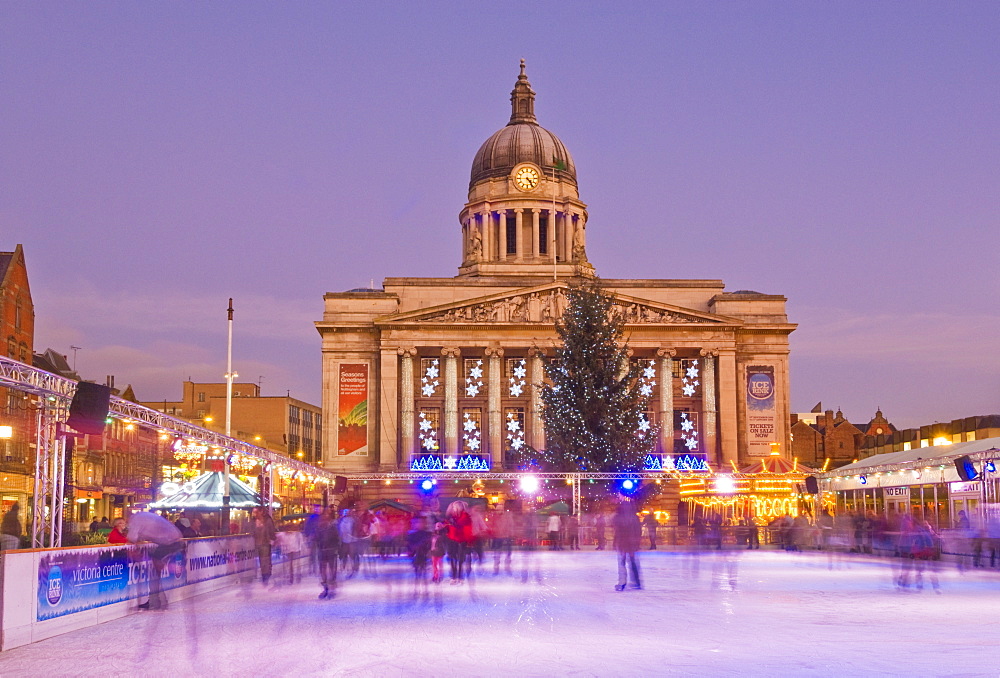 Ice skaters on the temporary Christmas outdoor ice skating rink in the Old Market Square in front of the Council House in the city centre, Nottingham, Nottinghamshire, England, United Kingdom, Europe