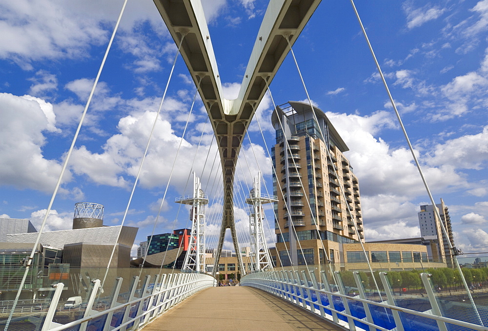 Modern architecture of new apartment buildings and the Lowry Centre fron the Millennium Bridge, Salford Quays, Greater Manchester, England, United Kingdom, Europe