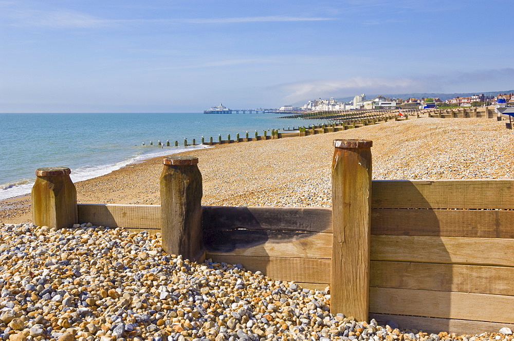 Pebble beach and groynes, Eastbourne Pier in the distance, Eastbourne, East Sussex, England, United Kingdom, Europe