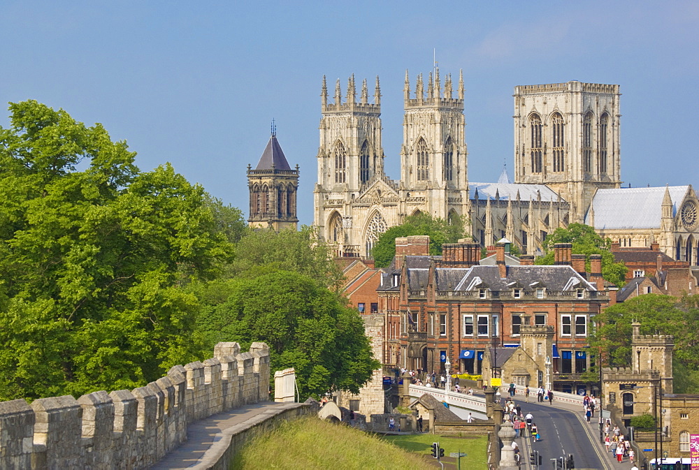 York Minster, northern Europe's largest Gothic cathedral, and a section of the historic city walls along Station Road, York, Yorkshire, England, United Kingdom, Europe