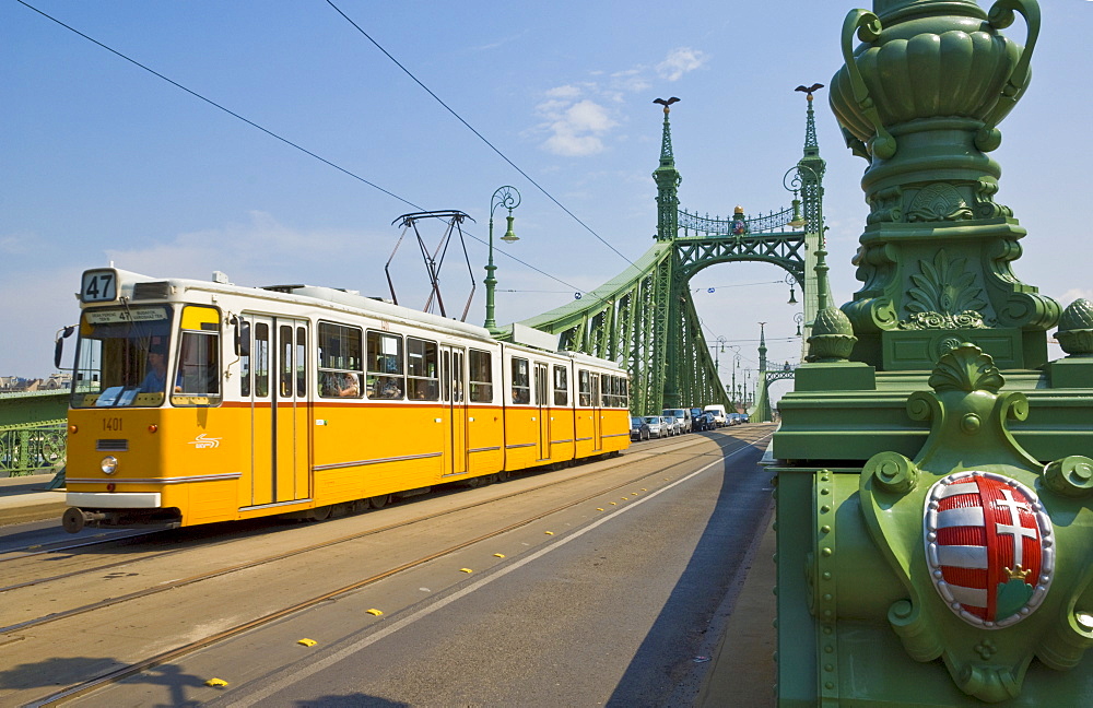 Yellow tram on The Liberty Bridge (Szabadsag hid), over the Rver Danube, Vamhaz Korut street, Budapest, Hungary, Europe