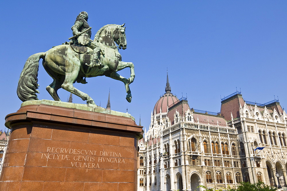 The neo-gothic Hungarian Parliament building front entrance, designed by Imre Steindl, with an equestrian statue of Ferenc Rakoczi II in foreground, Budapest, Hungary, Europe