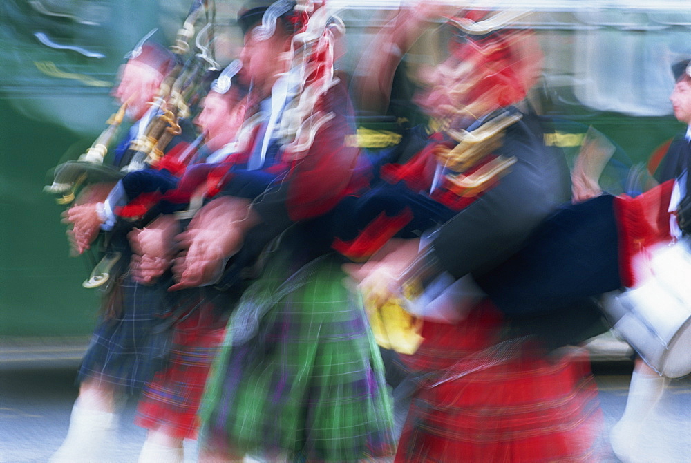 Motion blur, a group of Scottish Highland pipers wearing traditional tartan clothing, Edinburgh, Lothian, Scotland, United Kingdom, Europe