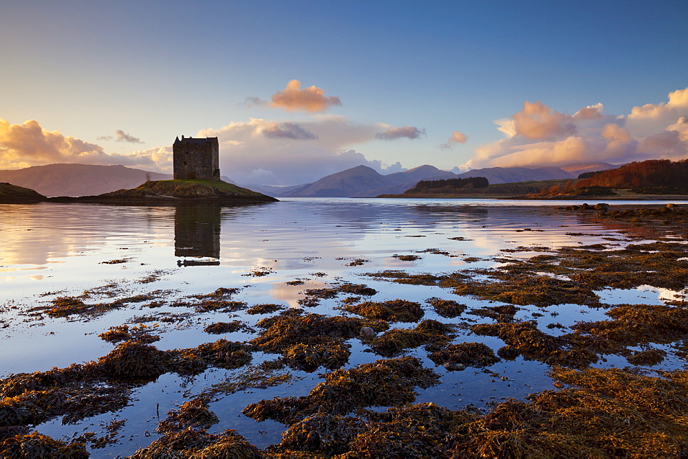 Silhouette of Castle Stalker, a Tower House or Keep, used often as a film set, at sunset, Loch Laich, an inlet off Loch Linnhe, Port Appin, Argyll, Highlands, Scotland, United Kingdom, Europe