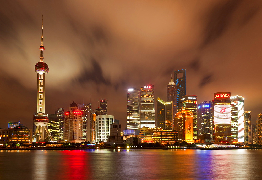 City skyline at night with Oriental Pearl Tower and Pudong skyscrapers across the Huangpu River, Shanghai, China, Asia