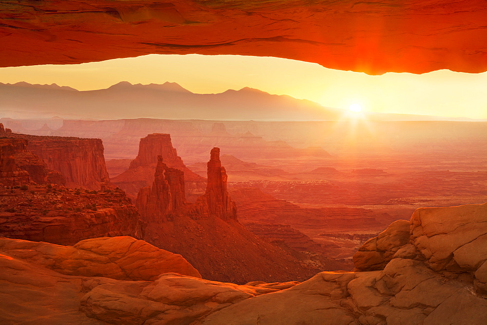 Sunrise over La Sal Mountains, Washer Woman Arch, and Mesa Arch, Island in the Sky, Canyonlands National Park, Utah, United States of America, North America