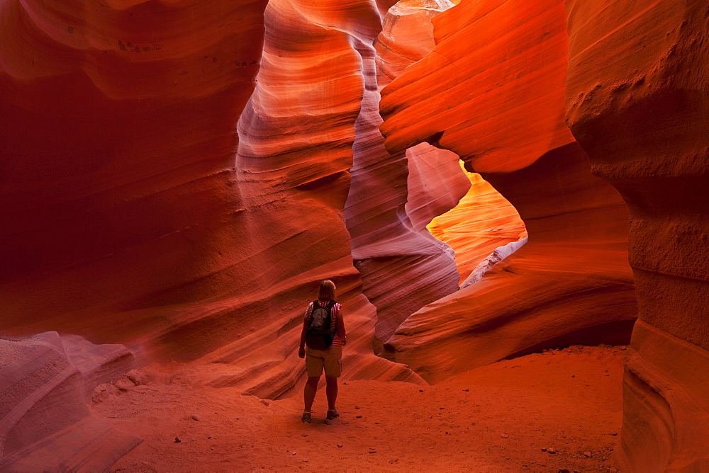 Female tourist hiker and Sandstone Rock formations, Lower Antelope Canyon, Page, Arizona, United States of America, North America 