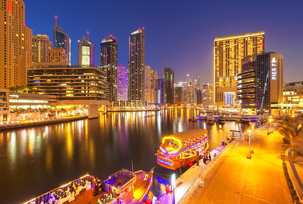 Dubai Marina skyline and tourist boats at night, Dubai City, United Arab Emirates, Middle East