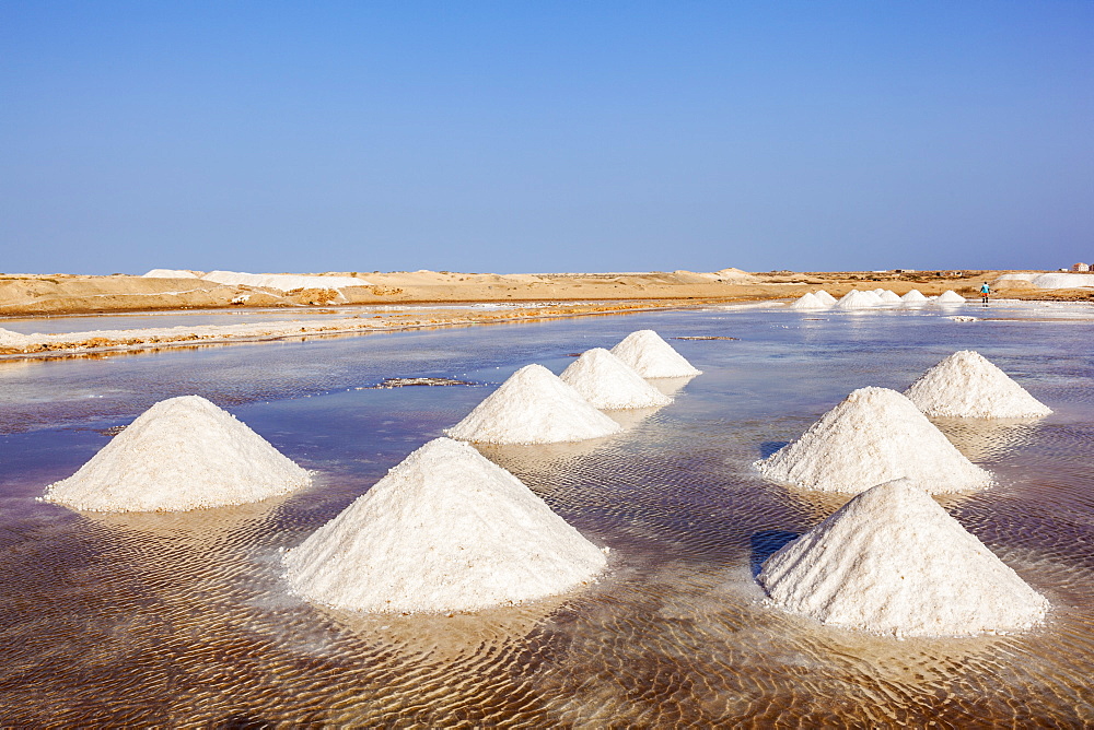 Piles of salt collected from natural salt pans at Salinas, just outside Santa Maria, Sal Island, Cape Verde, Atlantic, Africa