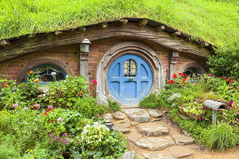 Hobbiton, wooden doors of Hobbit holes in the film set fictional village of Hobbiton, Matamata, North Island, New Zealand, Pacific