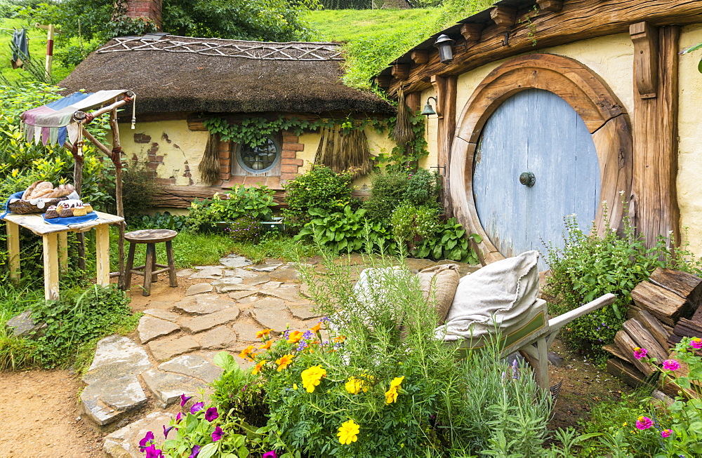 Hobbiton, wooden doors of Hobbit holes in the film set fictional village of Hobbiton, Matamata, North Island, New Zealand, Pacific