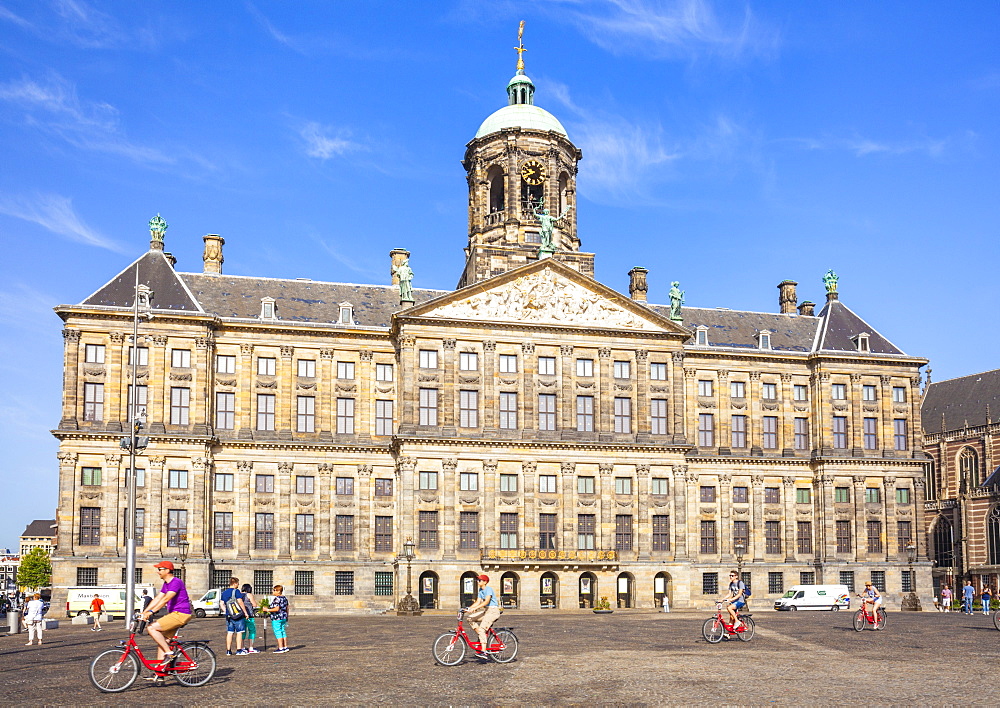 Amsterdam Royal Palace (Koninklijk Paleis) in Dam Square with cyclists, central Amsterdam, North Holland, Netherlands, Europe