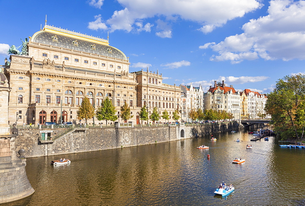 Prague National Theatre (Narodni divadlo) by the river Vltava with people in boats, Prague, Czech Republic, Europe