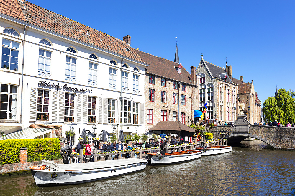 Boat tours on The Den Dijver Bruges canal in front of the Hotel De Orangerie in Bruges, Belgium, Europe