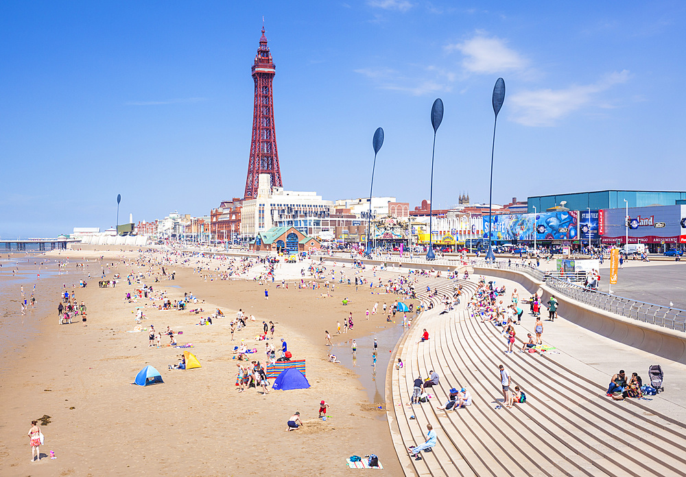 Blackpool Tower, Blackpool beach and seafront promenade with holidaymakers and tourists, Blackpool, Lancashire, England, United Kingdom, Europe