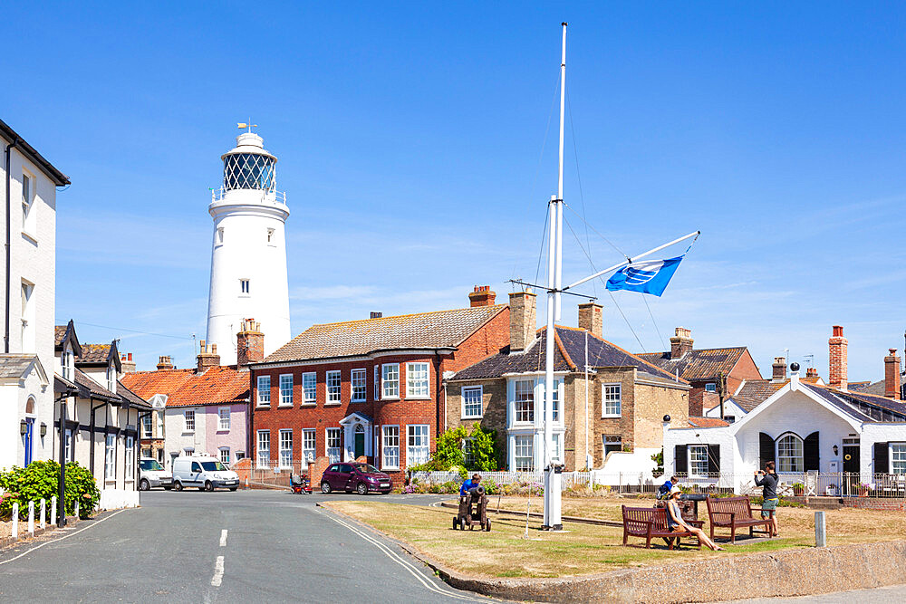 Southwold Lighthouse and houses, with people on a bench, St. James Green, East Cliff, Southwold, Suffolk, England, United Kingdom, Europe